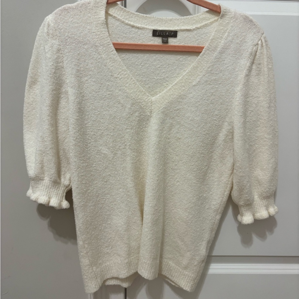 Cream sweater. The arms go to the elbow